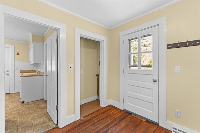 doorway with crown molding and dark hardwood / wood-style floors