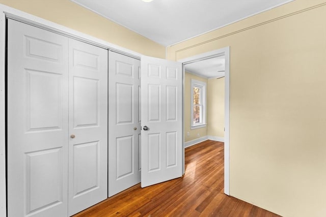 corridor with hardwood / wood-style floors