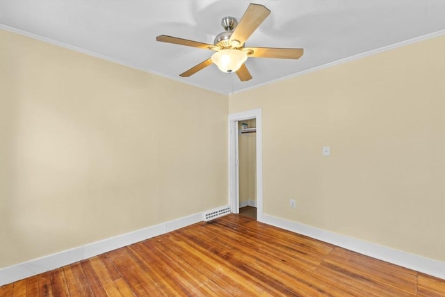 spare room featuring ceiling fan, ornamental molding, and wood-type flooring