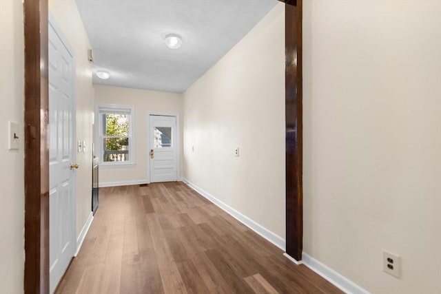 entryway with wood finished floors and baseboards