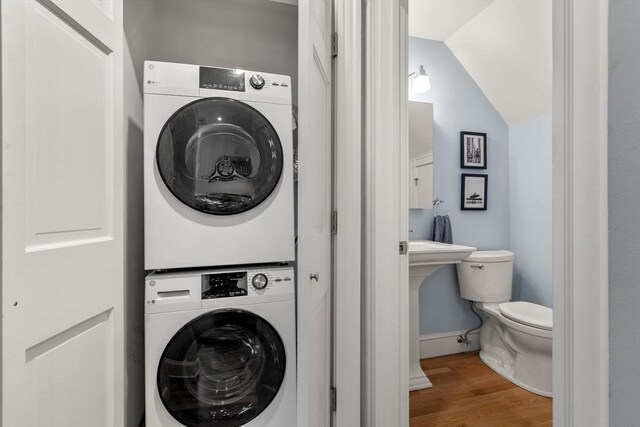 120 Norway St Unit 12, Boston, MA 02115 - washroom featuring estacked washer and dryer, wood finished floors, and baseboards