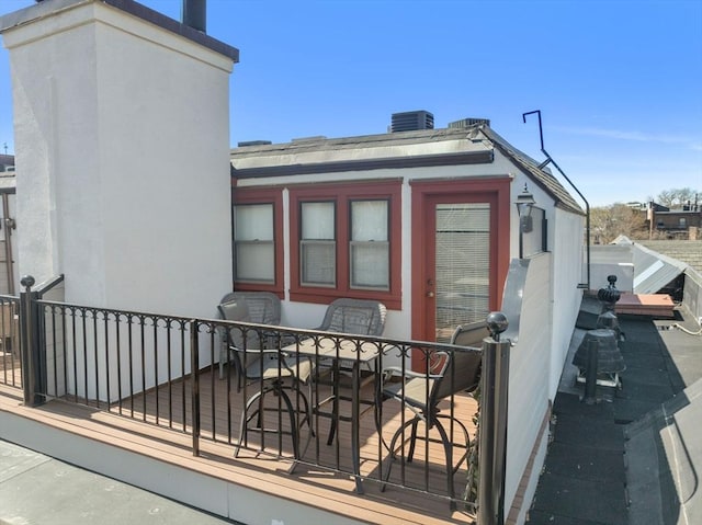 120 Norway St Unit 12, Boston, MA 02115 - back of house featuring stucco siding and cooling unit