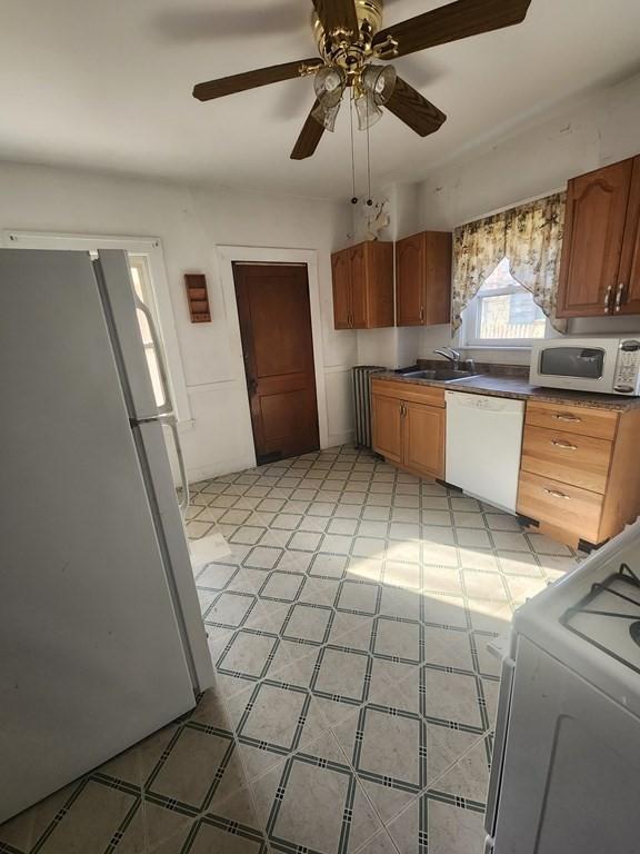 kitchen with ceiling fan, sink, and white appliances