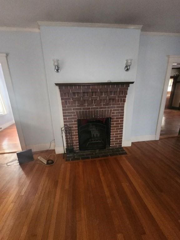 details with hardwood / wood-style flooring, ornamental molding, and a fireplace