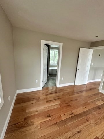 unfurnished room featuring hardwood / wood-style flooring