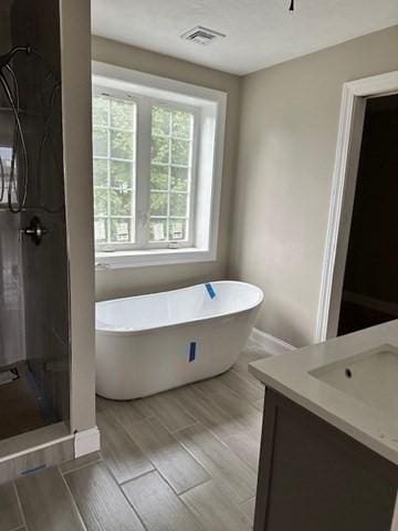 17 Mazzeo Dr, Randolph, MA 02368 - bathroom with vanity, a freestanding bath, wood finished floors, and a shower