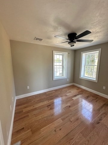 unfurnished room featuring ceiling fan and light hardwood / wood-style flooring