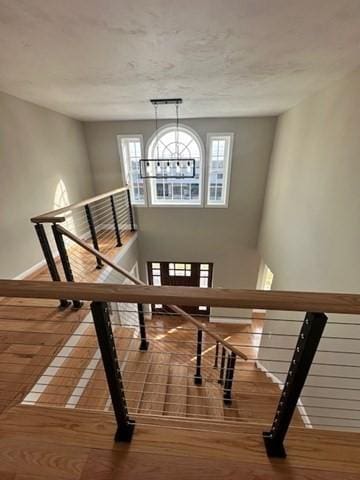17 Mazzeo Dr, Randolph, MA 02368 - stairway featuring wood finished floors, a chandelier, and baseboards