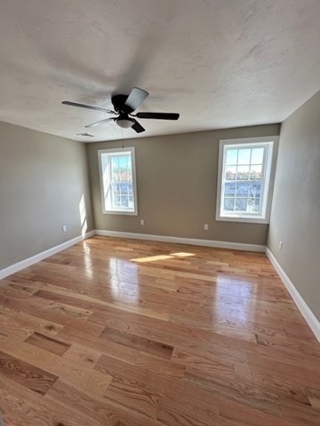 unfurnished room with ceiling fan and light hardwood / wood-style flooring