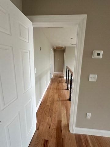 17 Mazzeo Dr, Randolph, MA 02368 - hallway featuring wood finished floors, attic access, and baseboards
