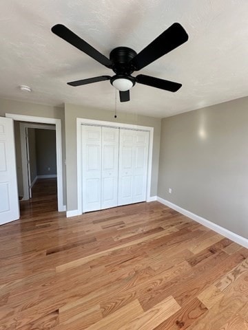 unfurnished bedroom featuring ceiling fan and light hardwood / wood-style floors