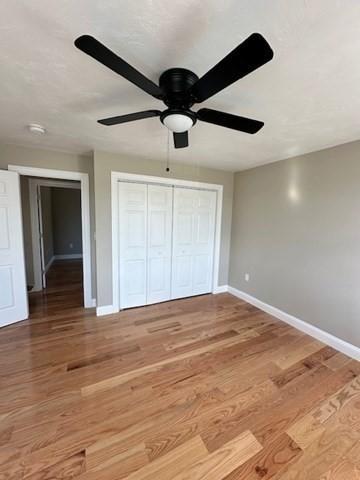 unfurnished bedroom with hardwood / wood-style flooring and ceiling fan