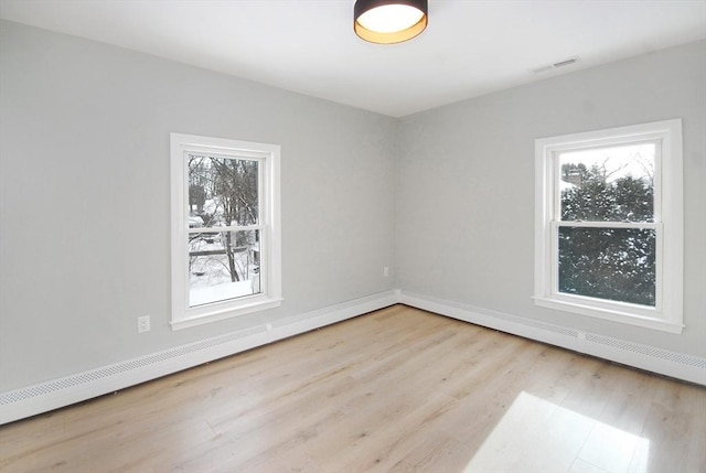 spare room featuring visible vents and wood finished floors