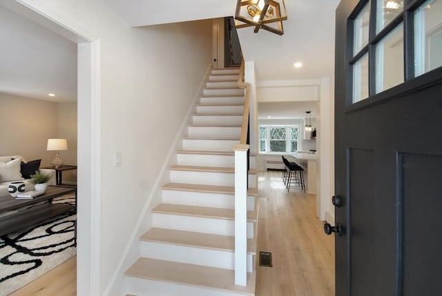 entrance foyer featuring stairs, light wood-type flooring, and recessed lighting