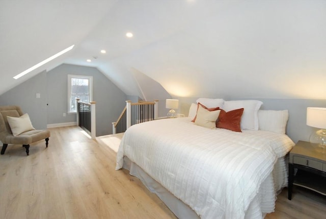 bedroom featuring light wood-style floors, lofted ceiling with skylight, and recessed lighting