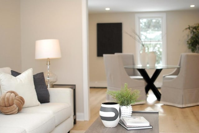 living area with recessed lighting, baseboards, and wood finished floors