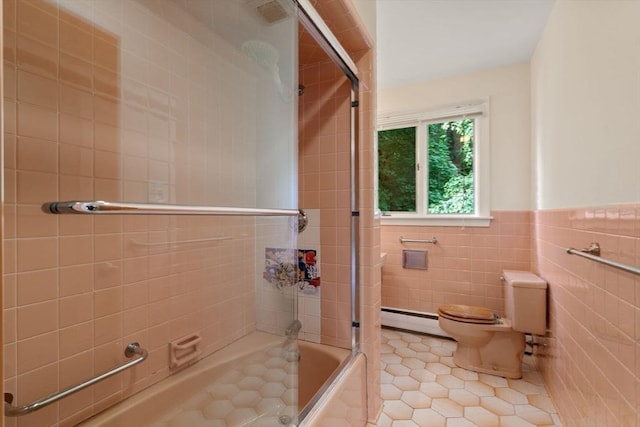 61 Sevland Rd, Newton, MA 02459 - bathroom with tile walls, tile patterned floors, a baseboard heating unit, combined bath / shower with glass door, and wainscoting