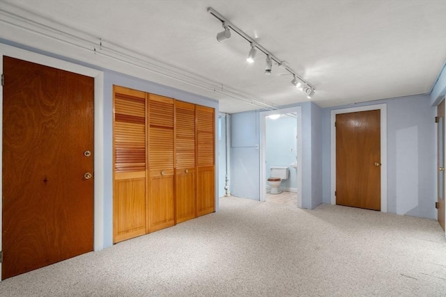 61 Sevland Rd, Newton, MA 02459 - unfurnished bedroom featuring carpet, connected bathroom, and rail lighting