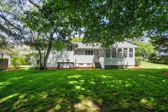 61 Sevland Rd, Newton, MA 02459 - rear view of house with a lawn and a sunroom