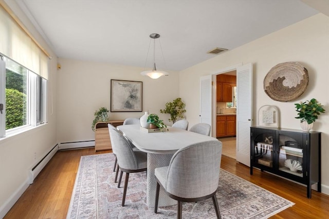 61 Sevland Rd, Newton, MA 02459 - dining space with wood finished floors, baseboard heating, and a baseboard heating unit