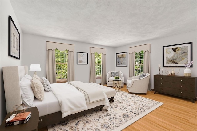 16 Parmenter Rd, Framingham, MA 01701 - bedroom featuring light wood-type flooring and a textured ceiling
