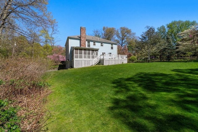 16 Parmenter Rd, Framingham, MA 01701 - back of house with a sunroom, a chimney, a yard, and a wooden deck
