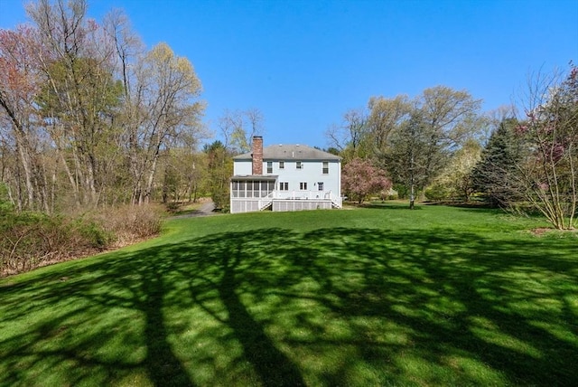 16 Parmenter Rd, Framingham, MA 01701 - back of property with a sunroom, a yard, and a chimney