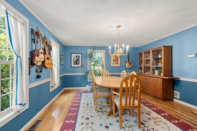 16 Parmenter Rd, Framingham, MA 01701 - dining area featuring a chandelier, wood finished floors, and ornamental molding
