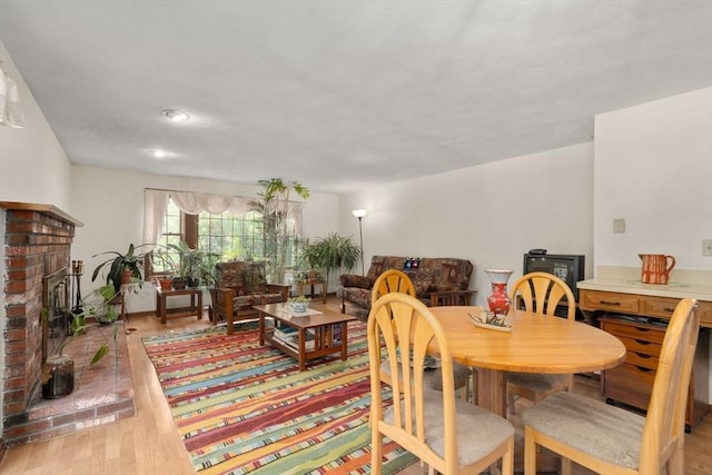 16 Parmenter Rd, Framingham, MA 01701 - dining area featuring a brick fireplace and light wood-type flooring