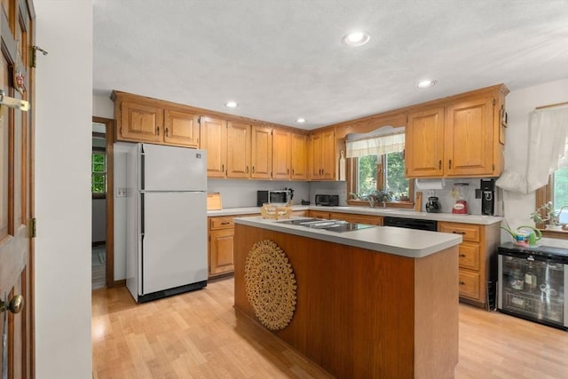 16 Parmenter Rd, Framingham, MA 01701 - kitchen featuring freestanding refrigerator, stovetop, light wood-style flooring, dishwasher, and light countertops