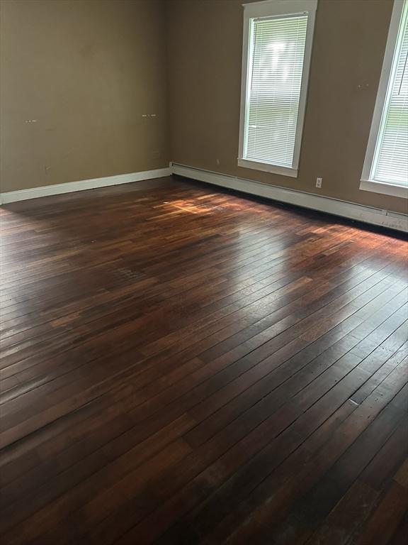 110 School St, Warren, MA 01083 - spare room featuring dark wood-style floors and a baseboard heating unit