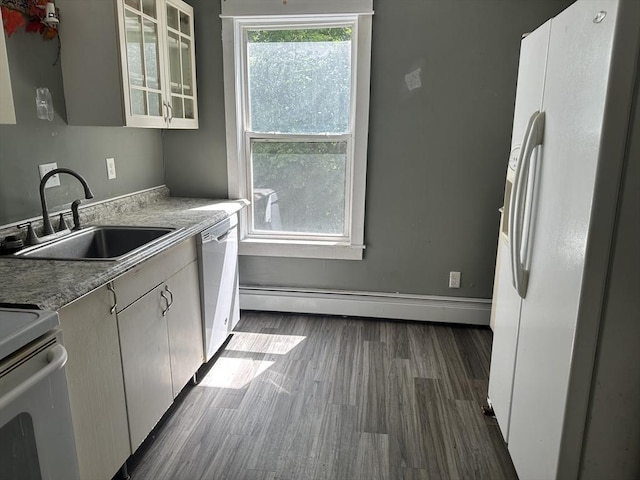 110 School St, Warren, MA 01083 - kitchen with white appliances, a baseboard heating unit, dark wood-type flooring, glass insert cabinets, and light countertops
