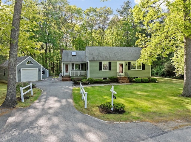 154 Mann Lot Rd, Scituate, MA 02066 - view of front of property featuring an outdoor structure, asphalt driveway, a front lawn, and covered porch