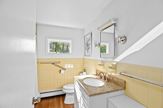 154 Mann Lot Rd, Scituate, MA 02066 - bathroom with baseboard heating, plenty of natural light, toilet, a wainscoted wall, and vanity