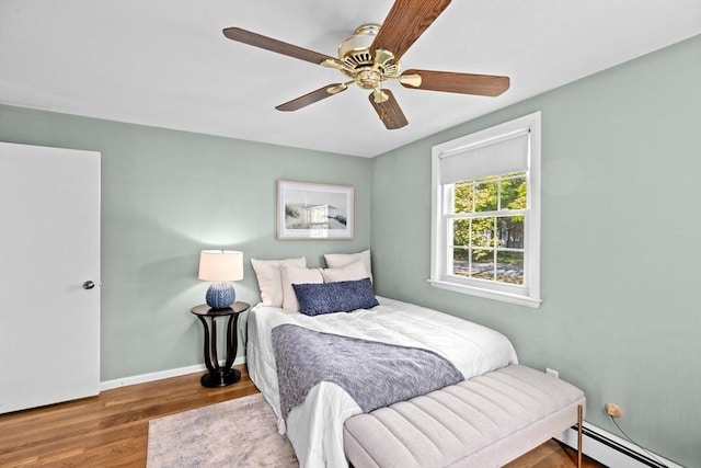 154 Mann Lot Rd, Scituate, MA 02066 - bedroom with a baseboard heating unit, wood finished floors, baseboards, and ceiling fan