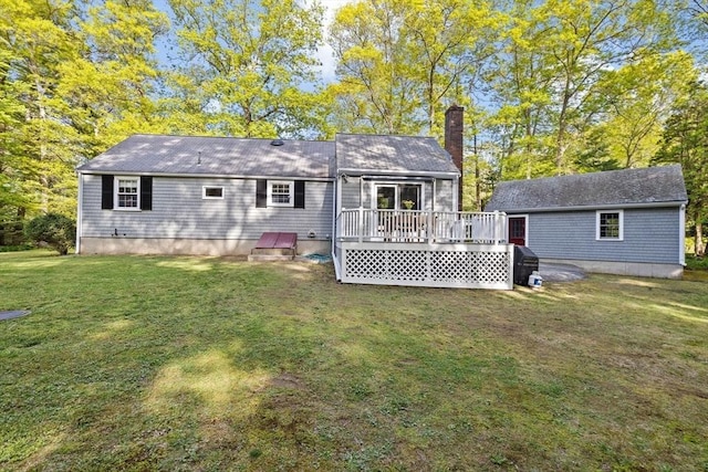 154 Mann Lot Rd, Scituate, MA 02066 - back of property featuring a wooden deck, a chimney, and a lawn