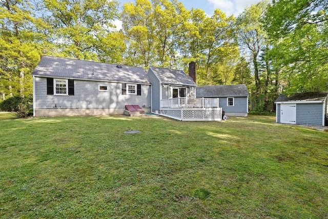 154 Mann Lot Rd, Scituate, MA 02066 - back of house with a deck, a storage unit, an outbuilding, and a yard
