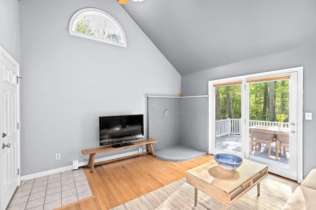 154 Mann Lot Rd, Scituate, MA 02066 - living room featuring a baseboard heating unit, high vaulted ceiling, wood finished floors, and baseboards