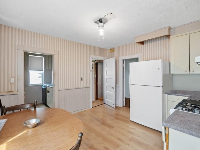 210-212 Brown St, Waltham, MA 02453 - kitchen featuring freestanding refrigerator, wallpapered walls, light wood-style flooring, dishwasher, and range