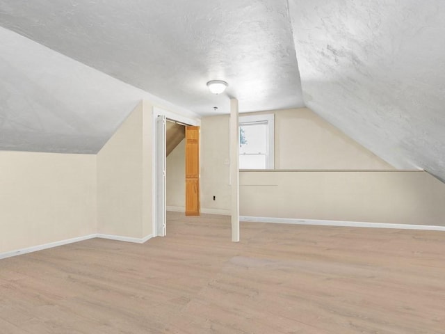 210-212 Brown St, Waltham, MA 02453 - additional living space featuring wood finished floors, lofted ceiling, and a textured ceiling