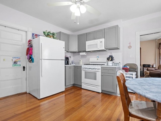 210-212 Brown St, Waltham, MA 02453 - kitchen featuring white appliances, gray cabinets, light countertops, light wood-style floors, and ceiling fan