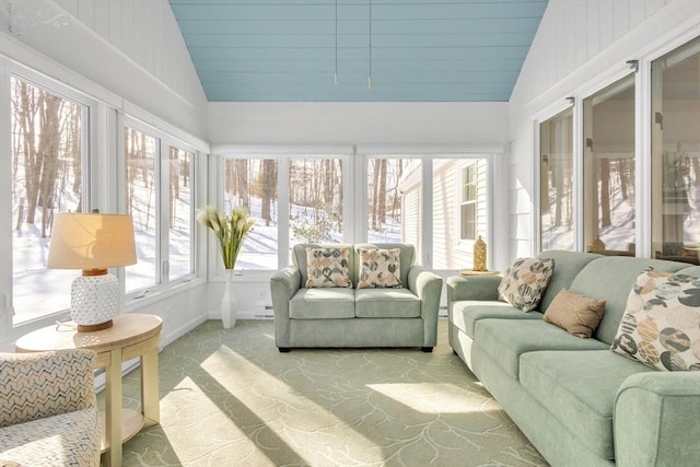 sunroom / solarium featuring a baseboard radiator and vaulted ceiling