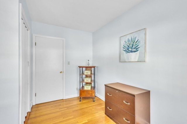 bedroom featuring baseboards and light wood finished floors