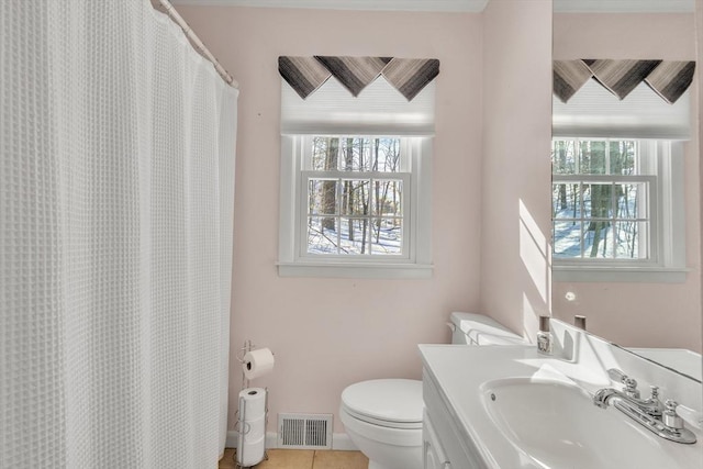 full bathroom featuring vanity, visible vents, baseboards, tile patterned flooring, and toilet