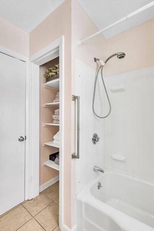 bathroom featuring shower / bath combination and tile patterned flooring