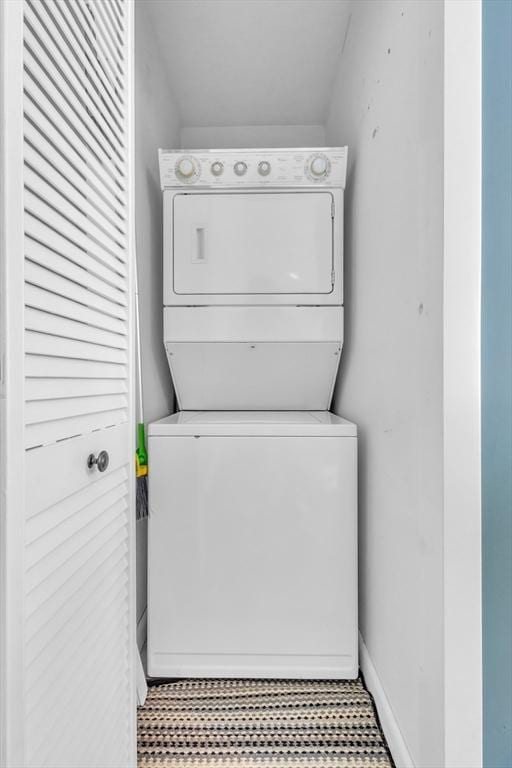 laundry area featuring laundry area and stacked washer / drying machine