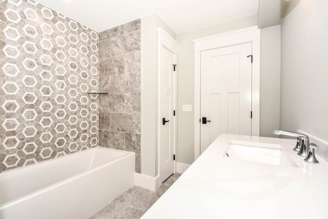 bathroom with vanity, tile patterned flooring, and tiled shower / bath