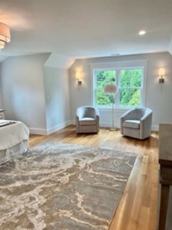 bedroom featuring lofted ceiling and hardwood / wood-style flooring