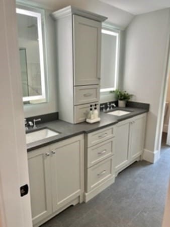 bathroom featuring vanity and lofted ceiling