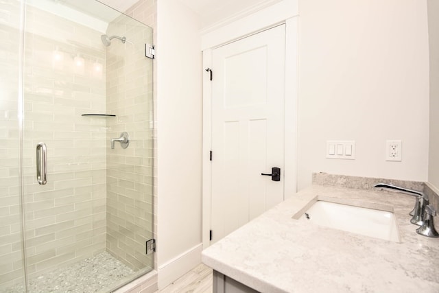 bathroom featuring an enclosed shower and vanity